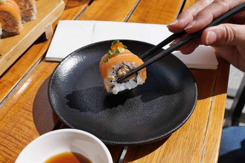 Sushi-Rolle im Restaurant Henssler at Home mit Stäbchen bereit zum Verzehr